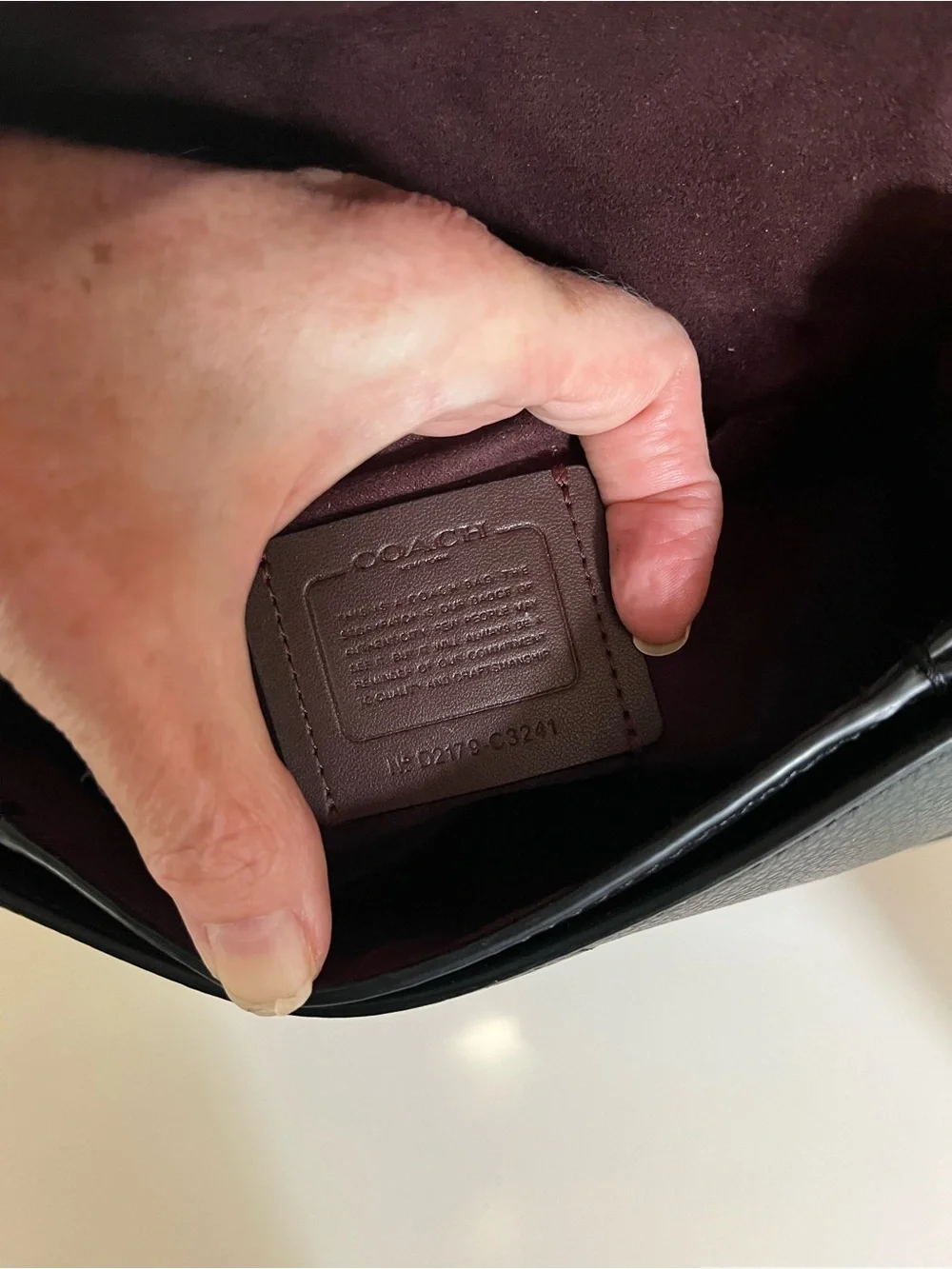 Coach Georgie crossbody saddle bag in black pebbled leather, gold tone hardware